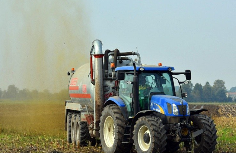 Tractor distributing liquid manure on a field