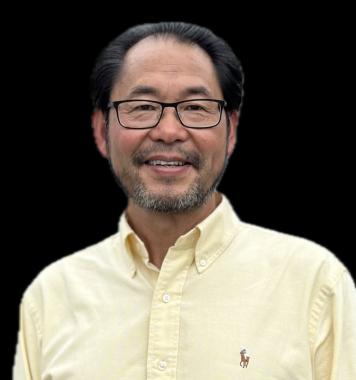 Headshot of Dr. Zheng. Wearing black glasses, a yellow short and looking straight at the camera. 